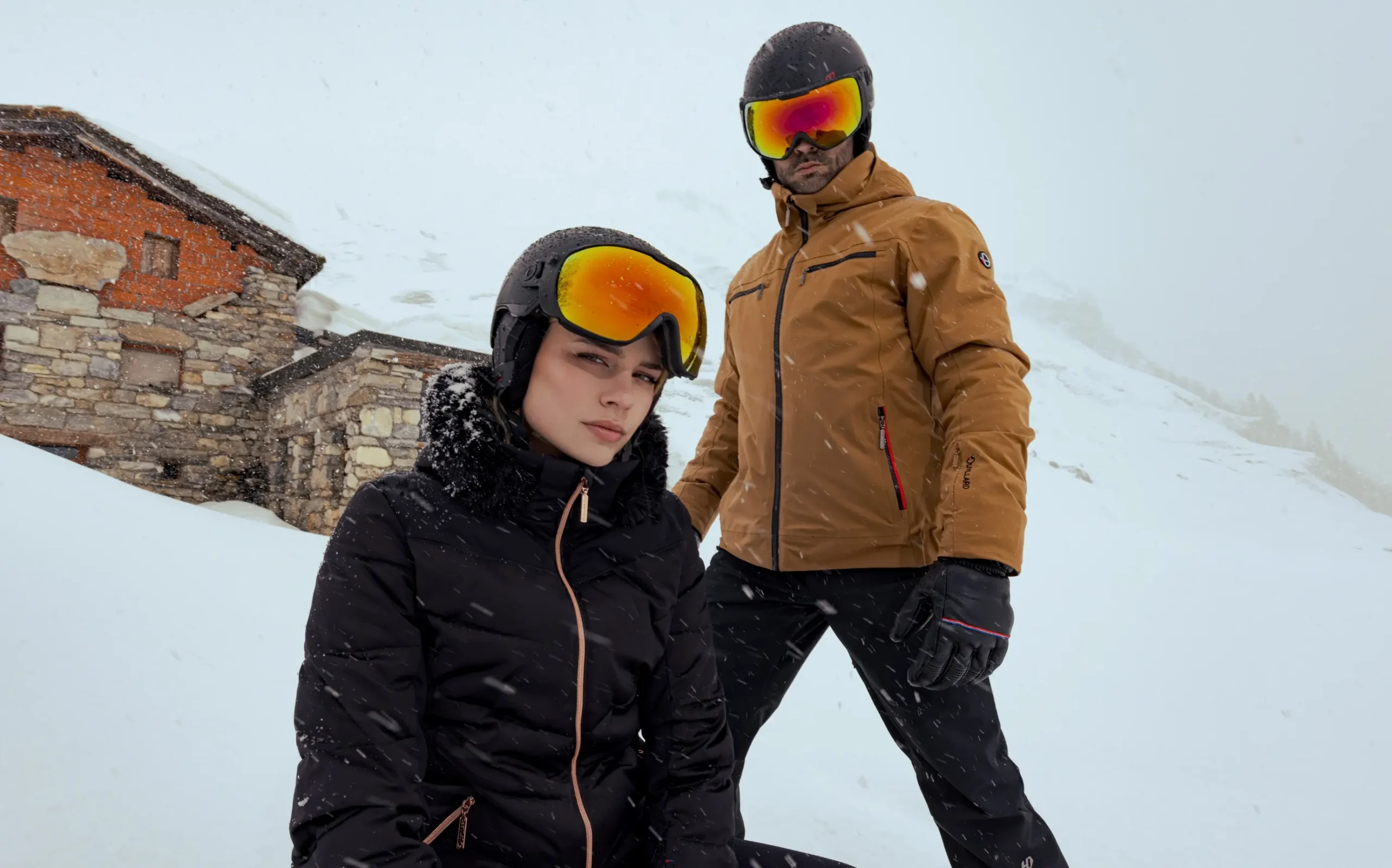 Woman and man in skiwear in snow
