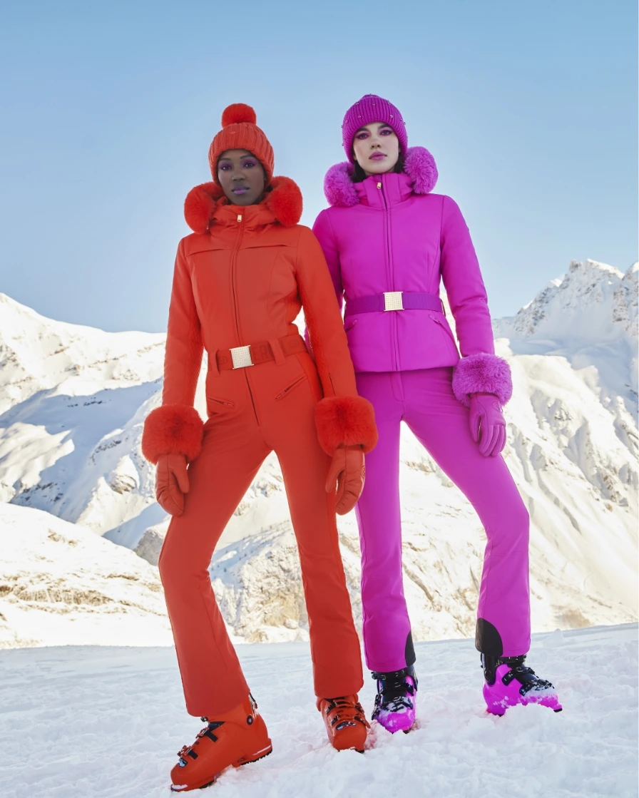 Two people in bright skiwear