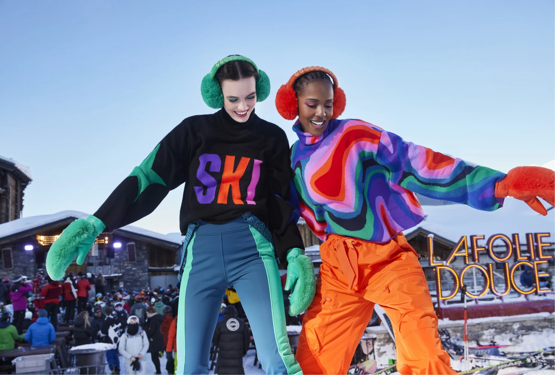 Two people wearing bright skiwear